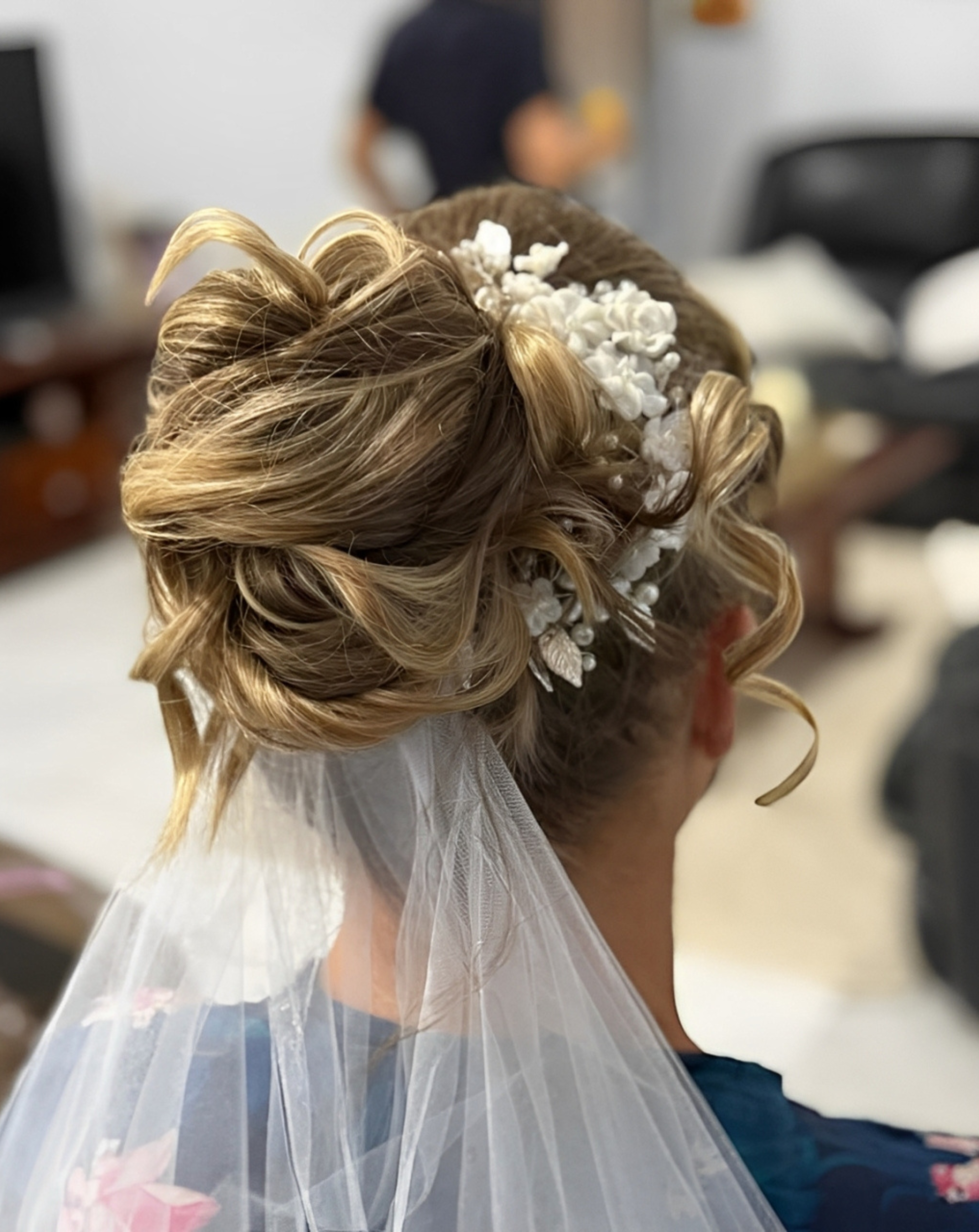 Elegant bridal hairstyle with intricate styling, perfect for a stunning wedding look, showcasing beauty and sophistication.